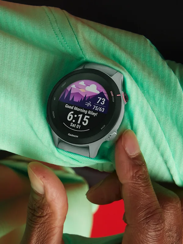 A person pressing a button on a Garmin watch